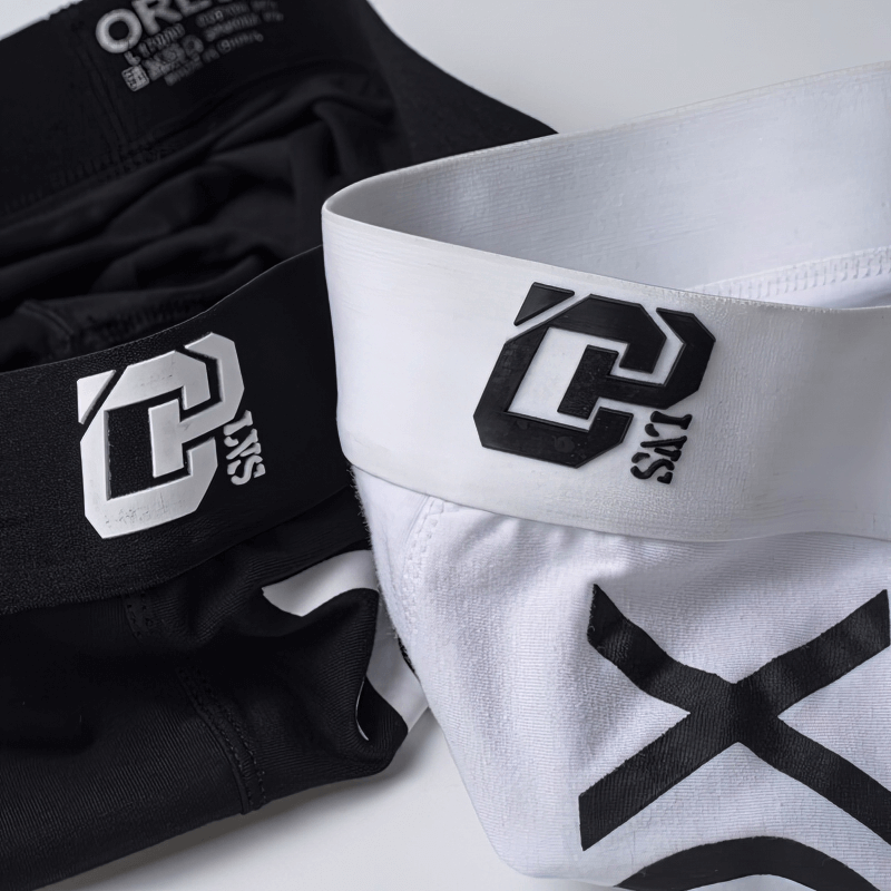 Close-up of Stylish Soft Sports Men's Boxers in black and white with logos, showcasing soft cotton for comfort and breathability.